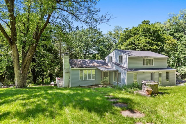 21 Wagon Ln, Brewster, NY 10509 - view of front of home with a chimney and a front lawn