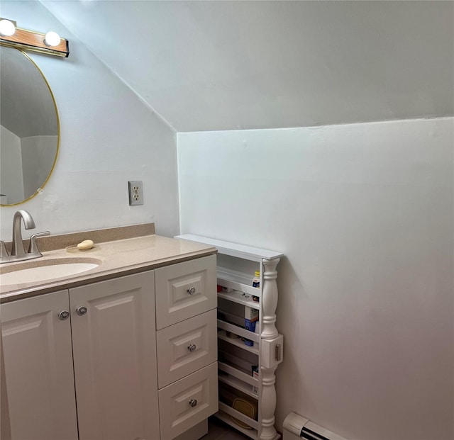 bathroom featuring vanity, lofted ceiling, and a baseboard heating unit
