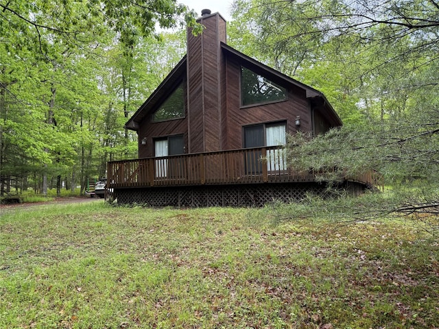 rear view of property with a chimney and a wooden deck