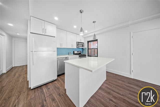 32-24 75th St, Jackson Heights, NY 11370 - kitchen with appliances with stainless steel finishes, recessed lighting, white cabinetry, dark wood finished floors, and light countertops
