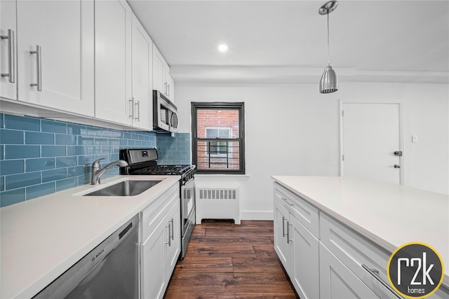 32-24 75th St, Jackson Heights, NY 11370 - kitchen with stainless steel appliances, radiator heating unit, a sink, dark wood-style floors, and tasteful backsplash