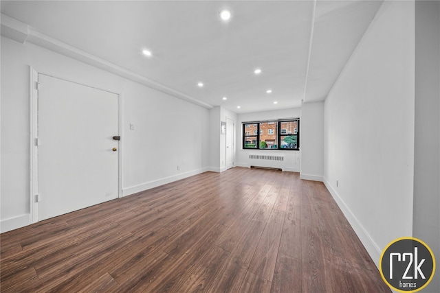 32-24 75th St, Jackson Heights, NY 11370 - unfurnished room with wood finished floors, radiator, recessed lighting, and baseboards