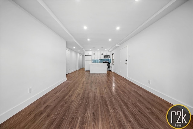32-24 75th St, Jackson Heights, NY 11370 - unfurnished living room with recessed lighting, baseboards, and dark wood-style floors