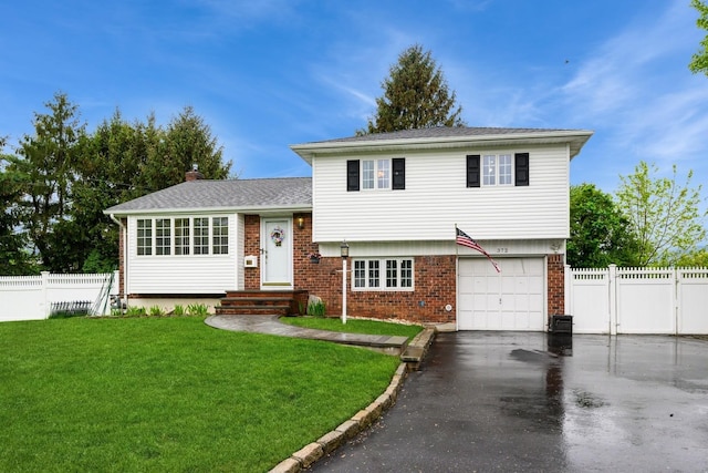 split level home with brick siding, driveway, a garage, roof with shingles, and a chimney