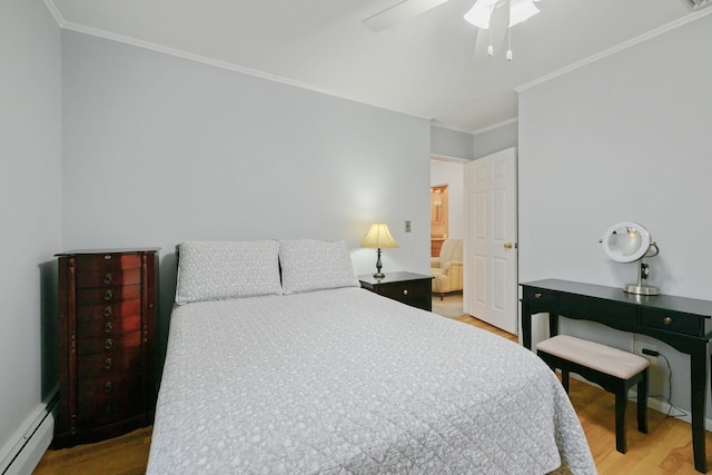 bedroom featuring a baseboard heating unit, wood finished floors, ornamental molding, and ceiling fan