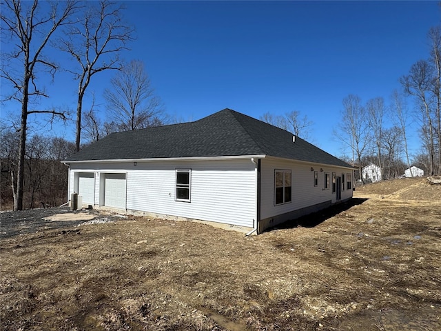 40 Wells Rd, Newburgh, NY 12550 - view of side of property featuring a garage and roof with shingles