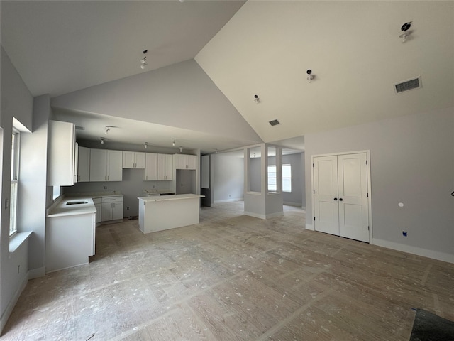 40 Wells Rd, Newburgh, NY 12550 - unfurnished living room featuring high vaulted ceiling, a sink, and baseboards