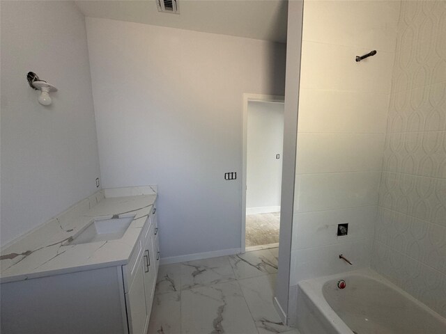 40 Wells Rd, Newburgh, NY 12550 - bathroom with marble look tiles, vanity, washtub / shower combination, and baseboards