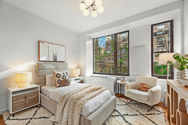 212 E 95th St, New York Manhattan, NY 10128 - bedroom featuring wood finished floors, a chandelier, and vaulted ceiling