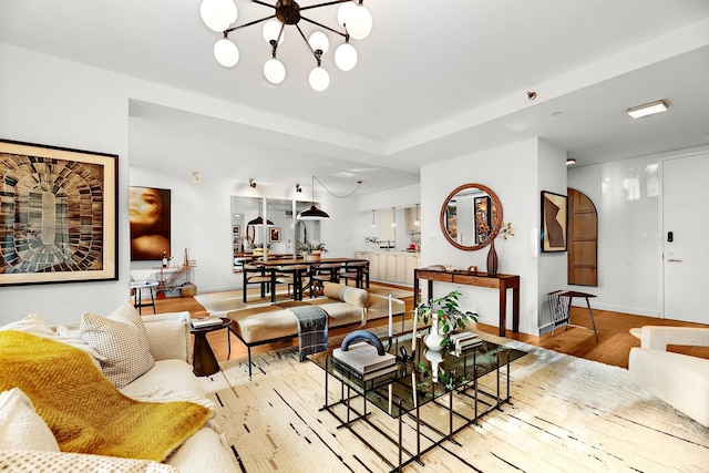 212 E 95th St, New York Manhattan, NY 10128 - living area with wood finished floors, baseboards, and a chandelier