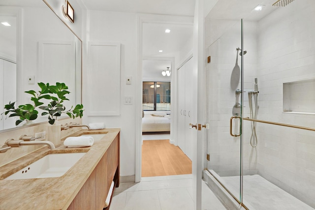 212 E 95th St, New York Manhattan, NY 10128 - ensuite bathroom featuring a shower stall, double vanity, tile patterned flooring, and recessed lighting
