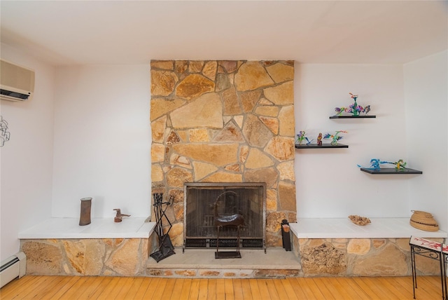 129 Boardman Rd, Poughkeepsie, NY 12603 - detailed view of a baseboard radiator, wood finished floors, a wall mounted AC, and a fireplace