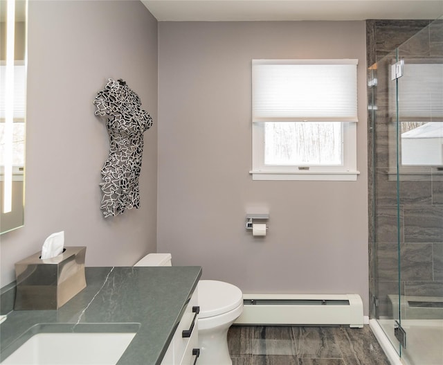 129 Boardman Rd, Poughkeepsie, NY 12603 - bathroom with a baseboard heating unit, vanity, a shower stall, and toilet