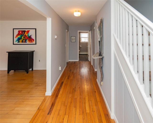 129 Boardman Rd, Poughkeepsie, NY 12603 - hall with light wood finished floors, baseboard heating, stairs, and baseboards