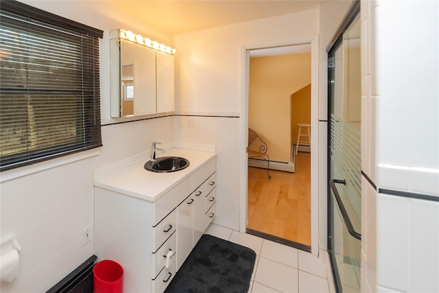 129 Boardman Rd, Poughkeepsie, NY 12603 - full bath featuring a baseboard radiator, tile patterned floors, vanity, and a shower with door