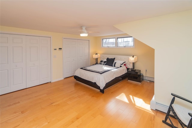 129 Boardman Rd, Poughkeepsie, NY 12603 - bedroom featuring two closets, light wood-style floors, a baseboard radiator, and a ceiling fan