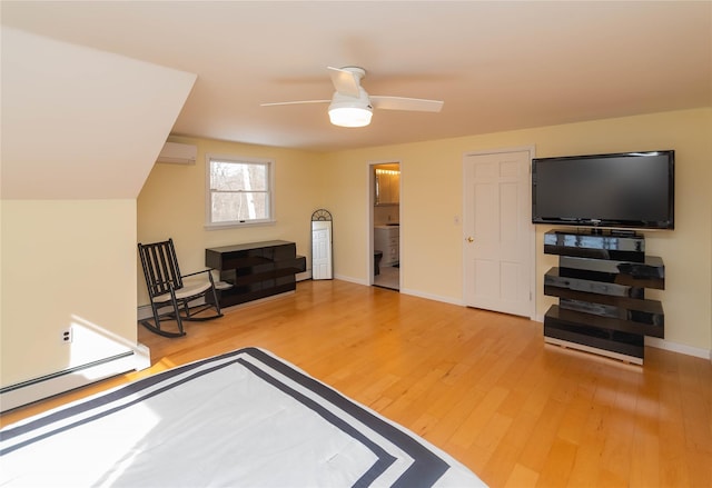 129 Boardman Rd, Poughkeepsie, NY 12603 - bedroom featuring an AC wall unit, wood finished floors, baseboards, and baseboard heating