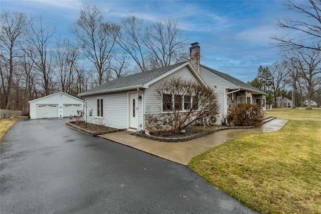 129 Boardman Rd, Poughkeepsie, NY 12603 - view of side of property with a detached garage, an outdoor structure, a chimney, a yard, and stone siding