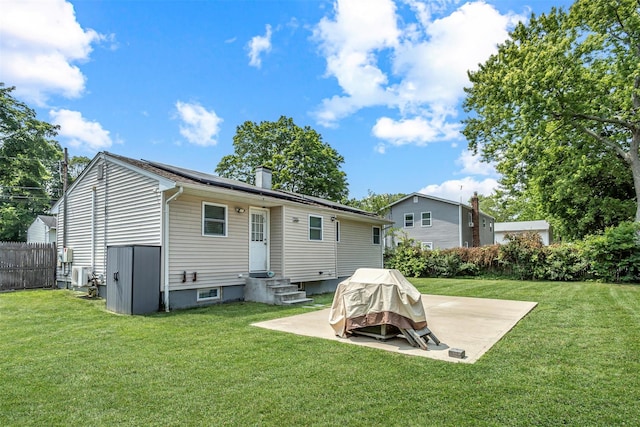 51 Andrews Ave, Wyandanch, NY 11798 - back of property featuring a patio, a chimney, and solar panels