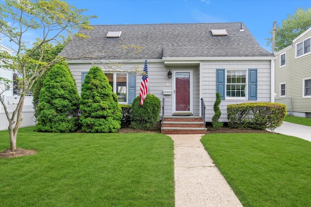 26 Wellfleet Rd, East Rockaway, NY 11518 - view of front of house featuring roof with shingles