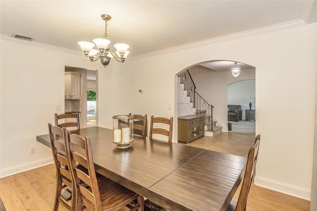 721 3rd Ave, East Northport, NY 11731 - dining area featuring arched walkways, a chandelier, ornamental molding, baseboards, and stairs