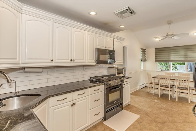 721 3rd Ave, East Northport, NY 11731 - kitchen with black appliances, a sink, decorative backsplash, lofted ceiling, and white cabinetry