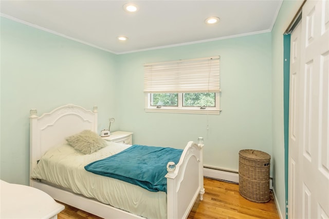 721 3rd Ave, East Northport, NY 11731 - bedroom with a baseboard heating unit, wood finished floors, recessed lighting, and ornamental molding