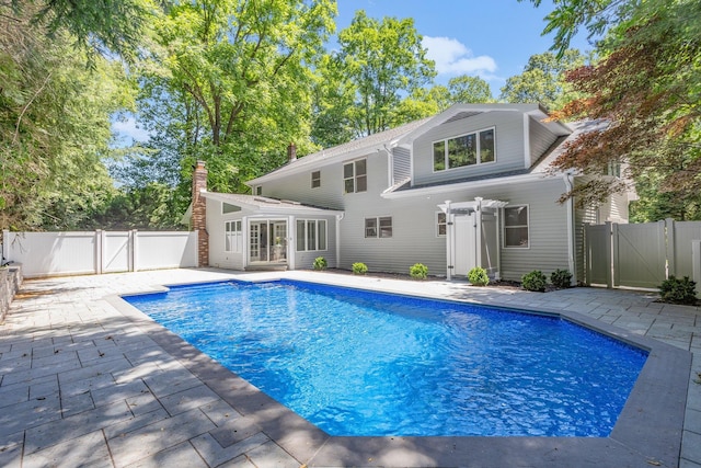 view of pool featuring a gate, a patio area, and a fenced backyard
