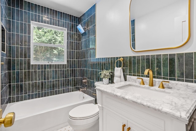 bathroom with tub / shower combination, toilet, tile walls, and vanity