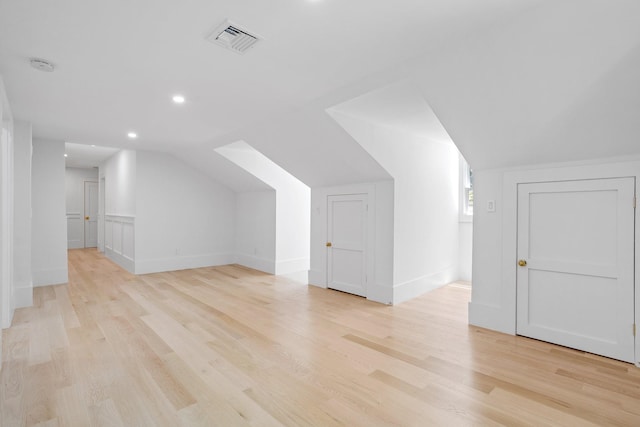 bonus room with lofted ceiling, light wood finished floors, recessed lighting, and baseboards
