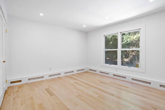 spare room featuring wood finished floors and recessed lighting