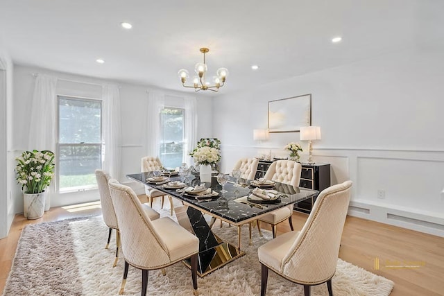 dining space with a chandelier, light wood-style floors, and recessed lighting
