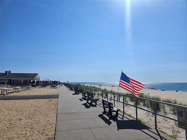 view of community with view of water and beach