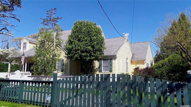 10 Phyllis Rd, Mastic Beach, NY 11951 - view of front facade featuring roof with shingles and a fenced front yard
