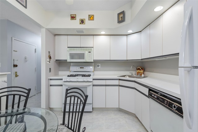 71-28 Sutton Pl Unit 3, Flushing, NY 11365 - kitchen featuring white appliances, a sink, light marble finish flooring, white cabinets, and recessed lighting