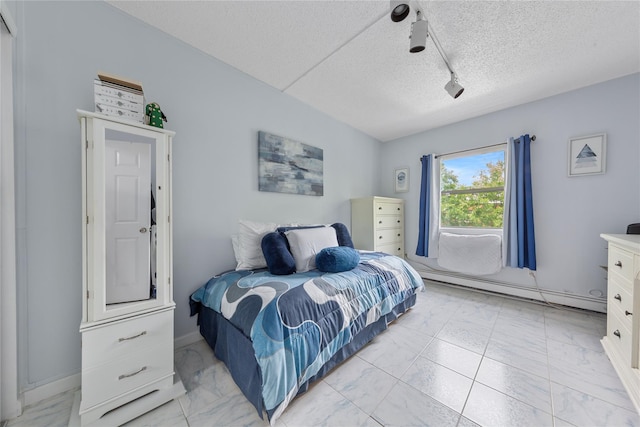 71-28 Sutton Pl Unit 3, Flushing, NY 11365 - bedroom featuring light marble finish flooring, track lighting, a textured ceiling, baseboard heating, and baseboards