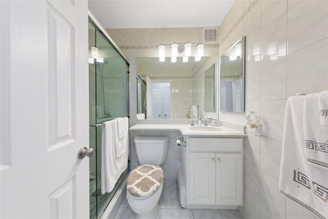 71-28 Sutton Pl Unit 3, Flushing, NY 11365 - bathroom featuring tile walls, a shower stall, toilet, and vanity
