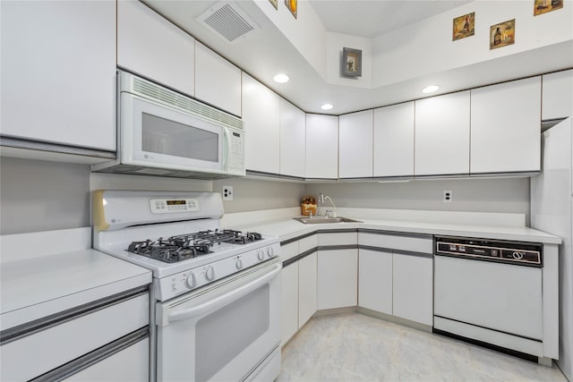71-28 Sutton Pl Unit 3, Flushing, NY 11365 - kitchen with white appliances, a sink, light countertops, white cabinetry, and recessed lighting