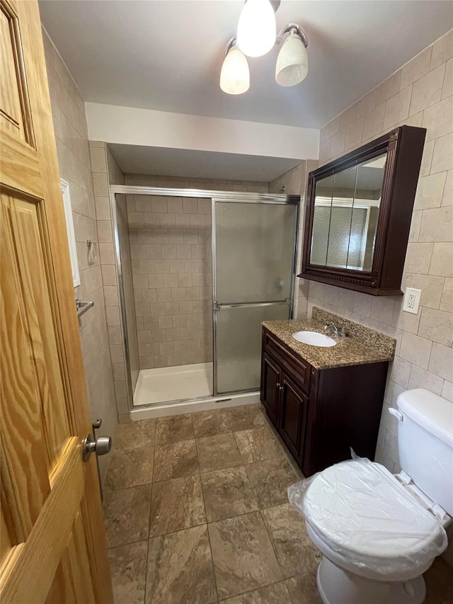 5431 Nurge Ave, Maspeth, NY 11378 - full bath with toilet, a shower stall, tile walls, and vanity
