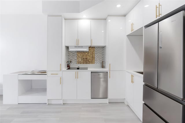 2805 Ocean Pkwy Unit 2C, Brooklyn, NY 11235 - kitchen featuring freestanding refrigerator, white cabinets, light countertops, decorative backsplash, and modern cabinets