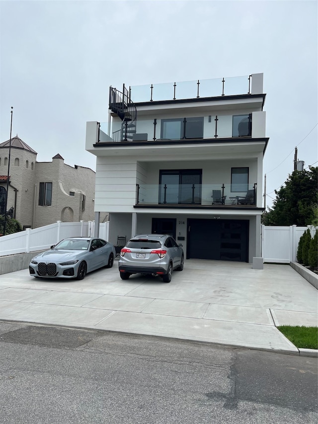 535 E Olive St, Long Beach, NY 11561 - view of front facade featuring driveway, a balcony, and an attached garage