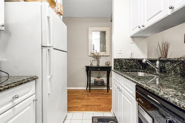 87-30 62nd Ave Unit 202, Rego Park, NY 11375 - kitchen featuring freestanding refrigerator, a sink, white cabinetry, and dark stone counters