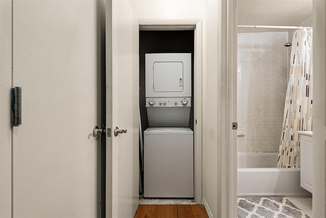 87-30 62nd Ave Unit 202, Rego Park, NY 11375 - washroom with stacked washer / drying machine and wood finished floors