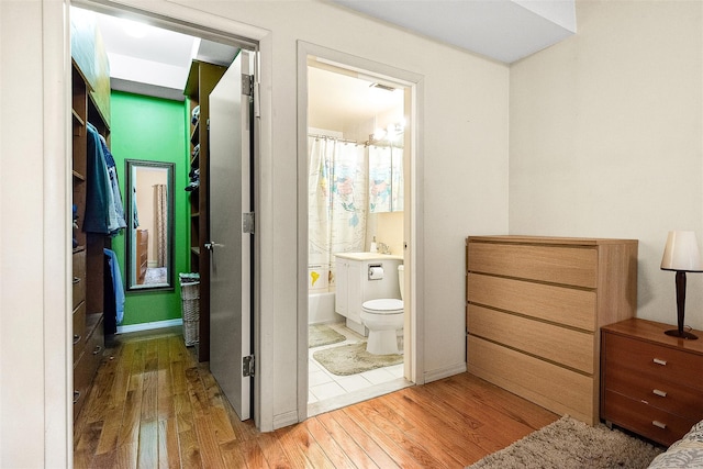 87-30 62nd Ave Unit 202, Rego Park, NY 11375 - bathroom with wood finished floors, toilet, and shower / tub combo