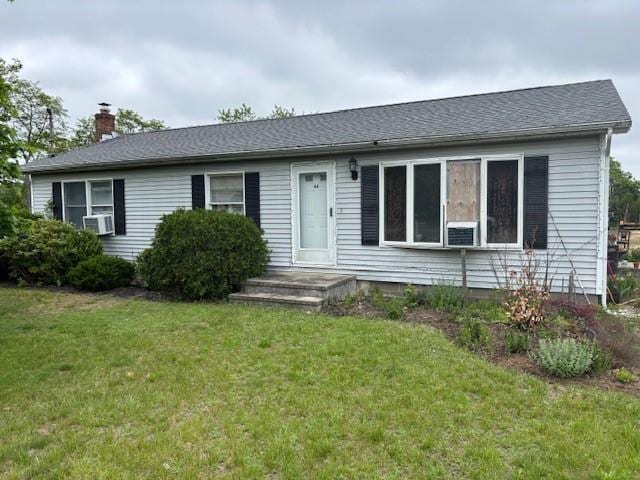 44 Goodridge Ave, Riverhead, NY 11901 - view of front facade with a chimney, a front lawn, and cooling unit