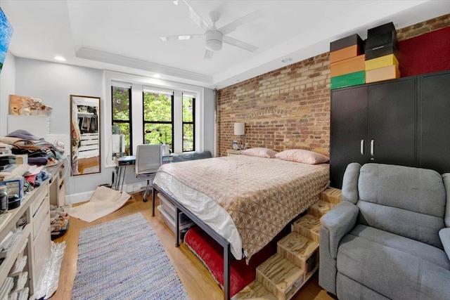 1185 Anderson Ave Unit 1F, Bronx, NY 10452 - bedroom with light wood finished floors, brick wall, a raised ceiling, a ceiling fan, and recessed lighting
