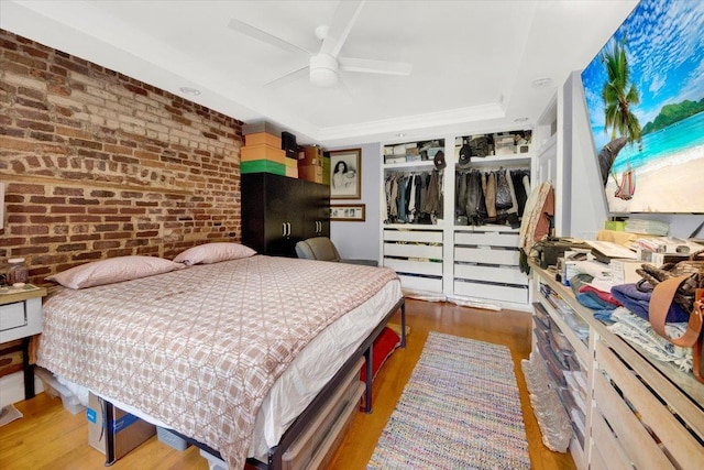 1185 Anderson Ave Unit 1F, Bronx, NY 10452 - bedroom with brick wall, wood finished floors, a tray ceiling, and ceiling fan