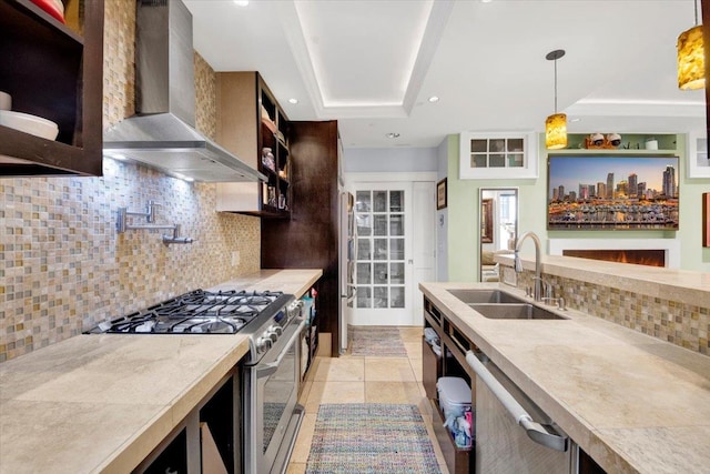 1185 Anderson Ave Unit 1F, Bronx, NY 10452 - kitchen featuring stainless steel appliances, a tray ceiling, wall chimney exhaust hood, a sink, and tasteful backsplash