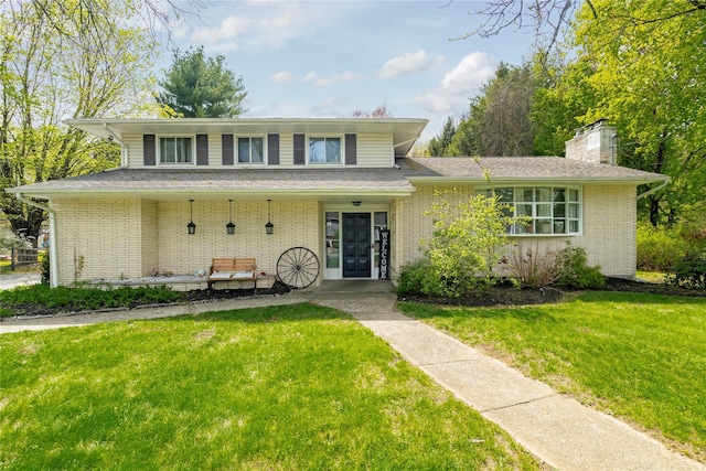 63 Wright Blvd, Hopewell Junction, NY 12533 - view of front of home featuring a front yard, brick siding, a chimney, and french doors