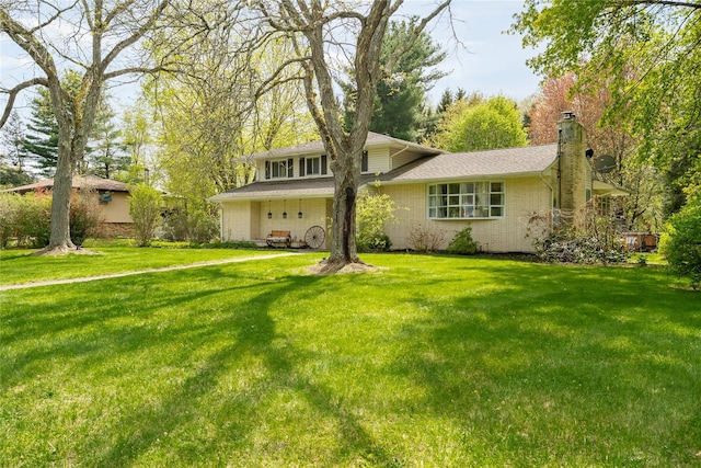 63 Wright Blvd, Hopewell Junction, NY 12533 - split level home with a front yard, a chimney, and brick siding
